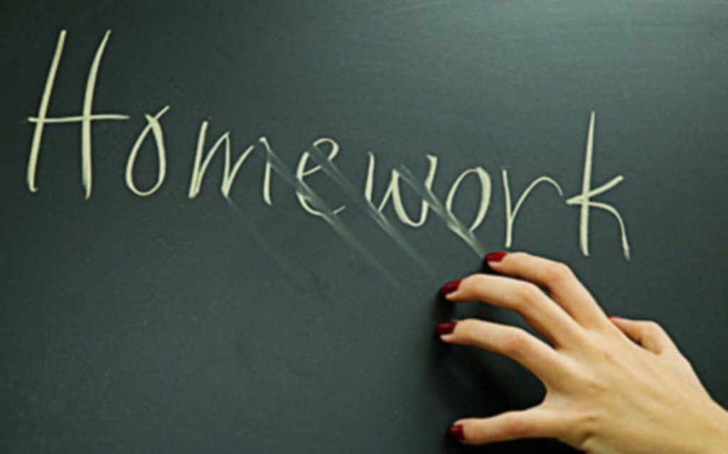 Nails against blackboard which says homework. A2BFW8